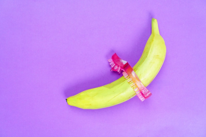 a cock ring being displayed for how to use on a banana